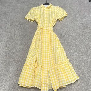 Yellow and white collared dress with button down front with tie waist